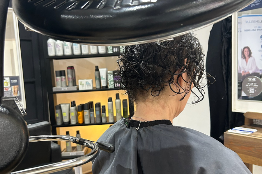 Gentle drying with a rotating drying machine at Time Hair & Beauty, Caterham, preserving curl shape and reducing frizz for a defined finish.